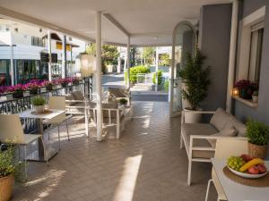 a patio of a restaurant with tables and chairs at Residence Mareo in Riccione +50 photos