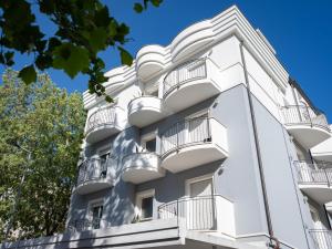 a white apartment building with balconies at Residence Mareo in Riccione