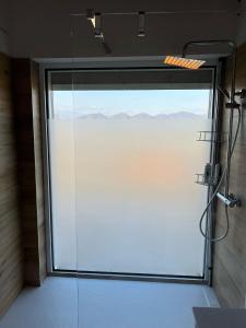 a large glass shower door in a bathroom at Dolce Vita in Altivole