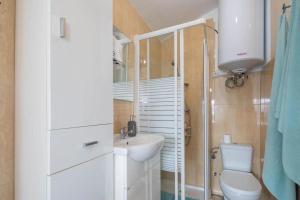 a small bathroom with a sink and a toilet at A Casita do Muelle in Cambados +12 photos
