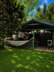 a hammock under a gazebo in a yard at Mała Tyczkówka in Stężyca