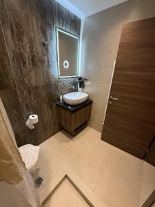 a bathroom with a sink and a mirror at Peralun Lux Apartments in Nea Peramos +17 photos