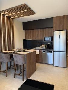 a kitchen with a table and a refrigerator at Peralun Lux Apartments in Nea Peramos
