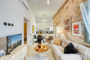 a living room with a couch and a tv at Kalamoti Suites in Kalamoti