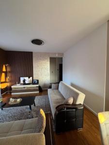 a living room with a couch and a table at Trebevic Skyline Apartman in Dovlići