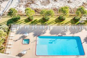 an overhead view of a swimming pool with palm trees at Regency Isle 802 in Orange Beach
