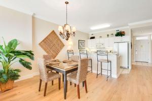 a dining room and kitchen with a table and chairs at Regency Isle 802 in Orange Beach +20 photos