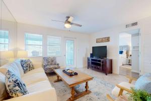 a living room with a couch and a tv at Jubilee Landing 302 in Orange Beach