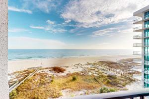 a view of the beach from the balcony of a building at Phoenix East 702 in Orange Beach