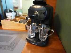 a coffee maker with two glasses on a table at Cruachan B & B in Tomintoul
