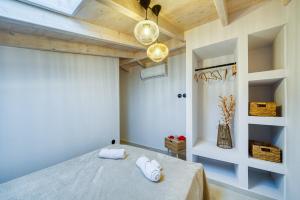 a bedroom with a bed with two towels on it at Kalamoti Suites in Kalamoti +52 photos