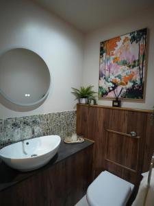 a bathroom with a sink and a mirror at Cruachan B & B in Tomintoul +32 photos