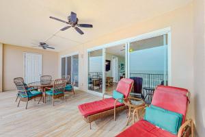 a living room with a table and chairs at Regency Isle 611 in Orange Beach