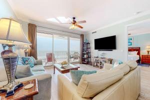 a living room with a couch and a flat screen tv at Regency Isle 611 in Orange Beach