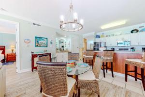 a kitchen and dining room with a table and chairs at Regency Isle 611 in Orange Beach +31 photos