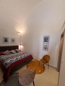 a bedroom with a bed and a table and a chair at La Casa di Lili in Nardò