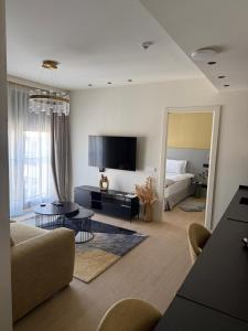 a living room with a couch and a bed at Dorćol Center Suites in Belgrade
