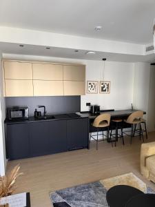 a kitchen with black cabinets and a table and chairs at Dorćol Center Suites in Belgrade