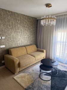 a living room with a couch and a table at Dorćol Center Suites in Belgrade +90 photos