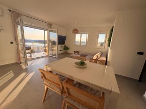 a living room with a table and chairs and a couch at Maris Loft Šimuni in Šimuni