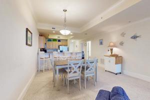 a dining room and kitchen with a table and chairs at Holiday Isle 618 in Dauphin Island