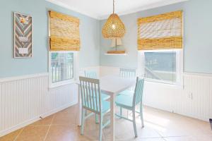 a dining room with a table and two chairs at Sunset Breeze #4 in Dauphin Island +13 photos