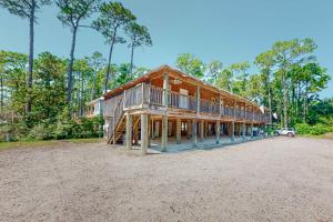 a large wooden house on a dirt lot at Sunset Breeze #4 in Dauphin Island