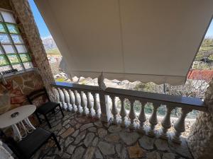 a balcony with a white railing and a window at Vila Silvi Bala in Pilur
