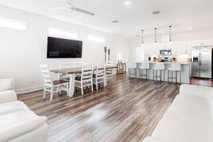a kitchen and dining room with a table and chairs at The Anchor Holds in Dauphin Island