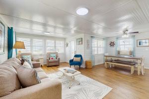 a living room with a couch and a piano at Macs Fish Camp in Dauphin Island