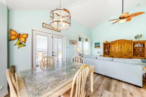 a dining room with a table and chairs at Sunset Beach in Dauphin Island