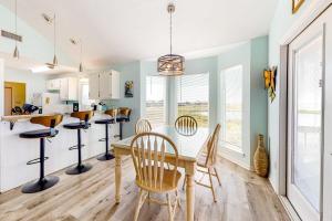 a kitchen and dining room with a table and chairs at Sunset Beach in Dauphin Island +25 photos