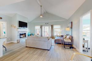 a living room with a couch and a fireplace at Bale Oasis in Dauphin Island +22 photos