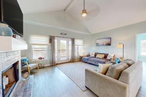 a living room with a couch and a fireplace at Bale Oasis in Dauphin Island