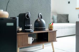 a coffee table with a black kettle on top of it at Rezidence 14 Nový Bor in Nový Bor