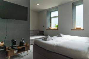 a bedroom with a large bed and a couch at Rezidence 14 Nový Bor in Nový Bor