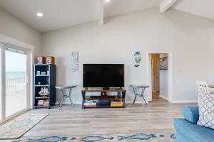 a living room with a flat screen tv at Sea the Gulf in Dauphin Island