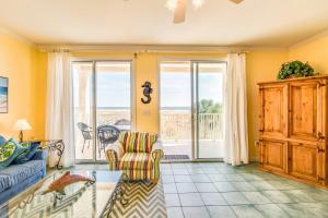 a living room with a couch and a chair at Gulf-front condo with lock-out feature shared pools & amazing views in Dauphin Island