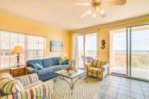 a living room with a blue couch and two chairs at Gulf-front condo with lock-out feature shared pools & amazing views in Dauphin Island