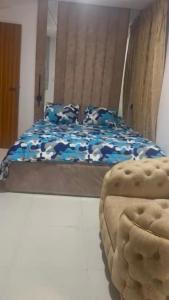 a bedroom with a bed and a ottoman at Yaba Elite Stays in Lagos +4 photos