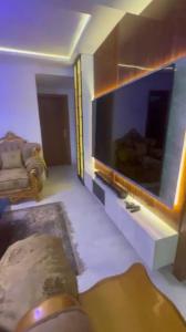a living room with a large flat screen tv at Yaba Elite Stays in Lagos