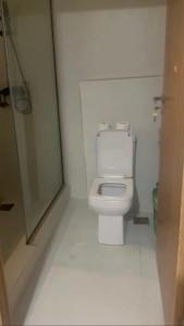 a bathroom with a toilet and a glass shower at Yaba Elite Stays in Lagos