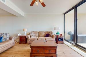 a living room with a couch and a table at Holiday Isle 413 in Dauphin Island