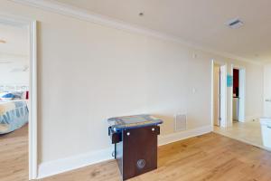 a room with a large white wall and a table at Holiday Isle 413 in Dauphin Island +29 photos