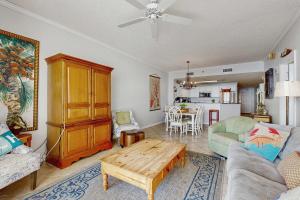 a living room with a couch and a table at Spacious beachfront condo with full kitchen shared pool and beach access in Gulf Shores