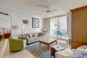 a living room with a couch and a table at Spacious beachfront condo with full kitchen shared pool and beach access in Gulf Shores