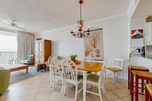 a dining room with a table and chairs at Spacious beachfront condo with full kitchen shared pool and beach access in Gulf Shores +15 photos