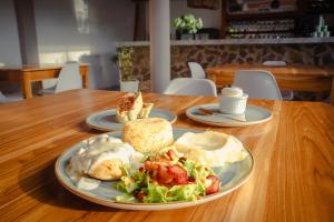 a table with two plates of breakfast food on it at Horizonte del Mar Hotel Boutique in Santa Marta