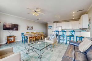 a living room with a couch and a table and chairs at Gulf-Front Condo with Balcony Shared Pools and Beach Access in Dauphin Island +27 photos