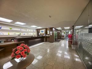 a lobby with a vase of red roses on a table at Hotel Golden Park Salvador By Nacional Inn in Salvador +28 photos